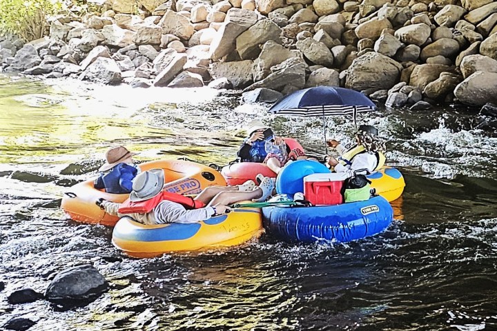 a group of people on a raft in the st croix river