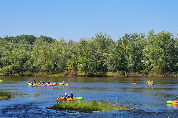 a group of people tubing in a body of water