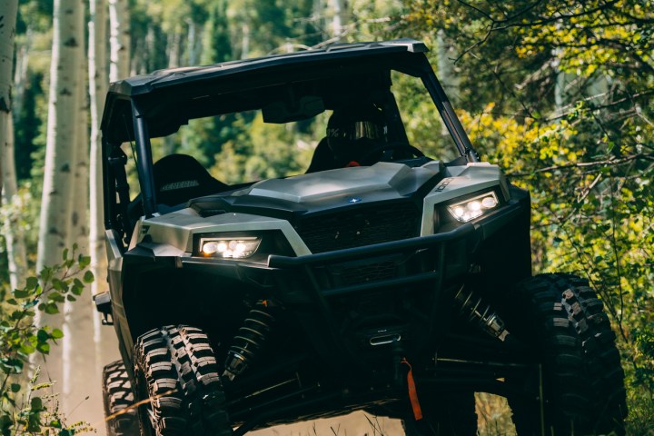 a atv driving down a dirt trail