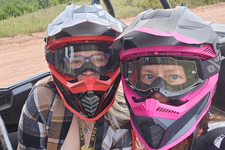 a man wearing a helmet sitting on a motorcycle