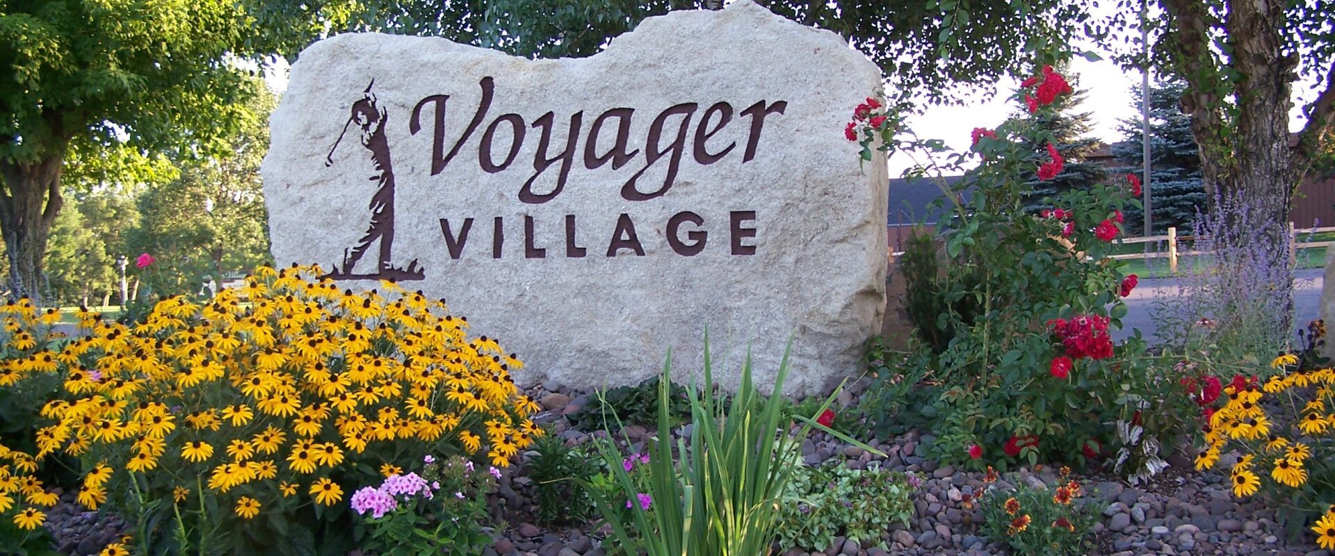 Voyager 5 a sign above a flower garden