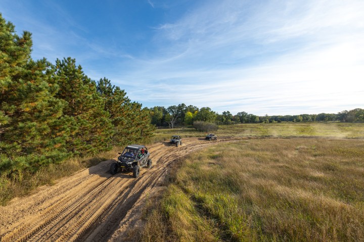 a motorcycle is parked on the side of a dirt field