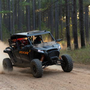 a truck driving down a dirt road
