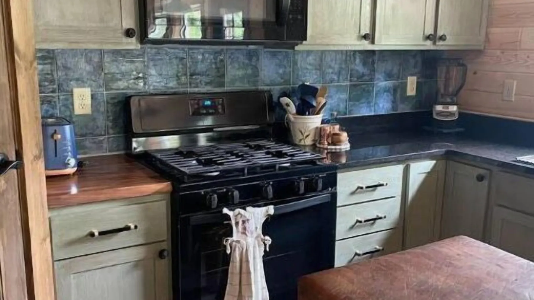 a kitchen with stainless steel appliances and wooden cabinets