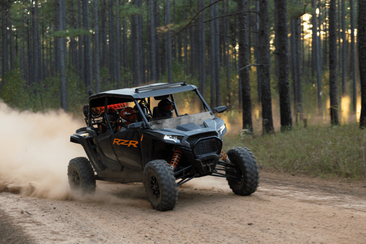 a truck driving down a dirt road