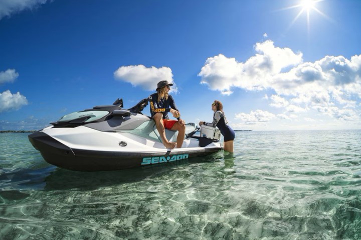 a man riding on the back of a boat in a body of water