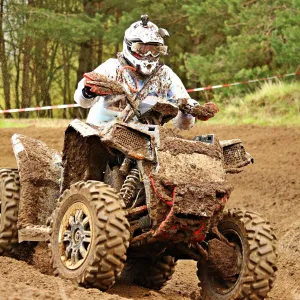 a man riding a bike down a dirt road