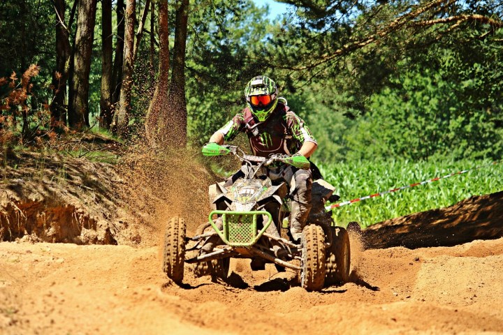 a man riding a bike down a dirt road