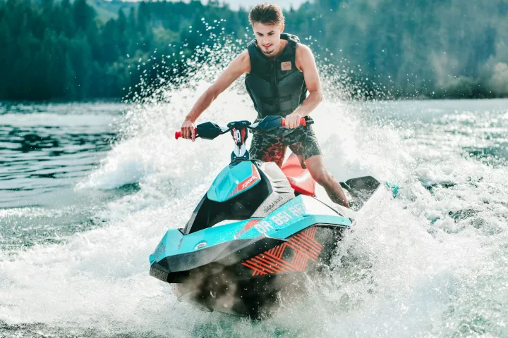 a girl riding a wave on top of a body of water