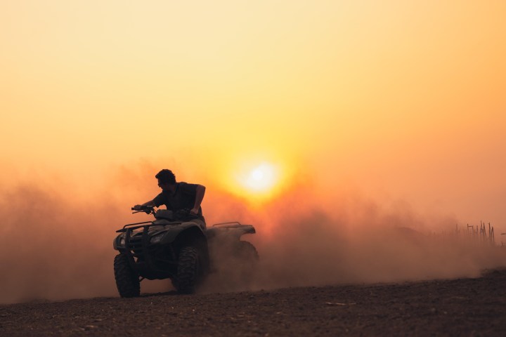 a man sitting at sunset