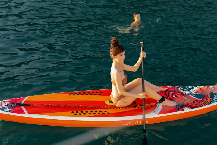 a person riding on the back of a boat on a body of water